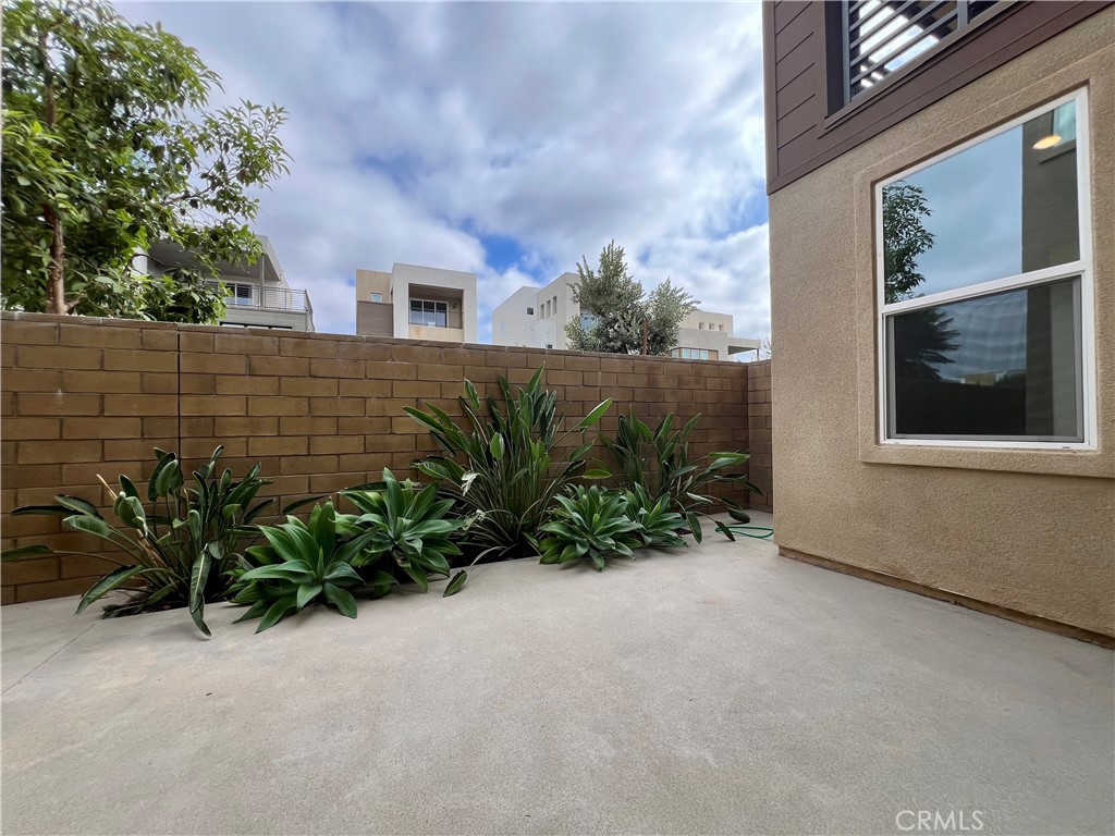 108 Chorus Irvine, CA 92618 - Photo 30 of 39 a view of backyard with plants and wooden fence