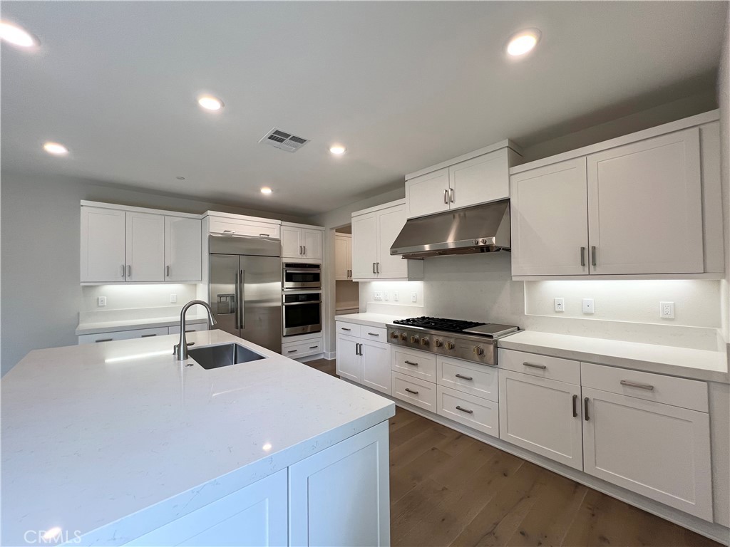 108 Chorus Irvine, CA 92618 - Photo 4 of 39 a kitchen with stainless steel appliances a sink stove and cabinets
