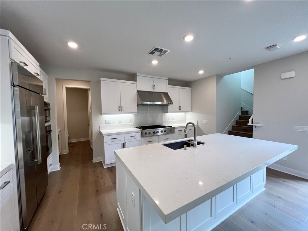 108 Chorus Irvine, CA 92618 - Photo 6 of 39 a kitchen that has a sink a refrigerator and a stove top oven