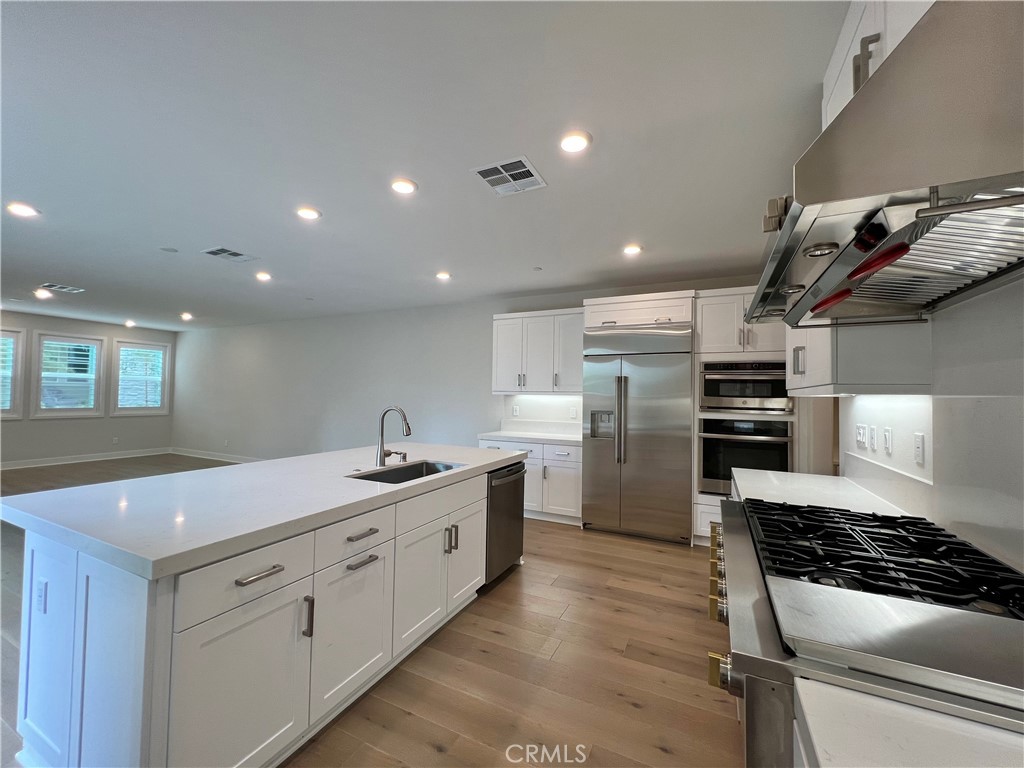 108 Chorus Irvine, CA 92618 - Photo 8 of 39 a kitchen with a sink stainless steel appliances and cabinets