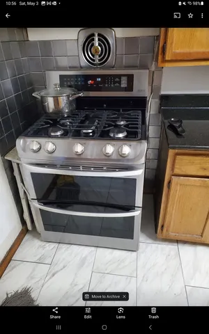 a stove top oven sitting inside of a kitchen
