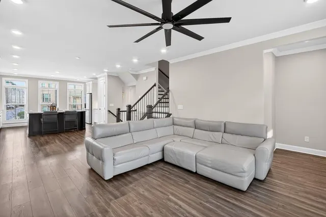 a living room with furniture and a wooden floor