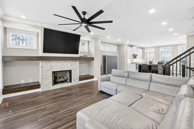 a living room with furniture a flat screen tv and a fireplace