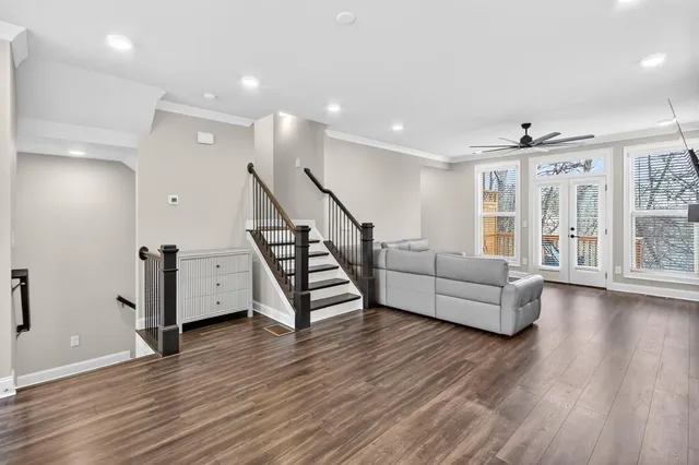 a living room with furniture and a wooden floor