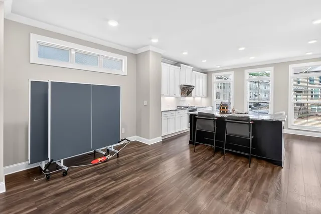 a view of a workspace with furniture and windows