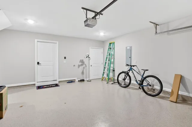 a view of an bike storage and utility room with a small yard