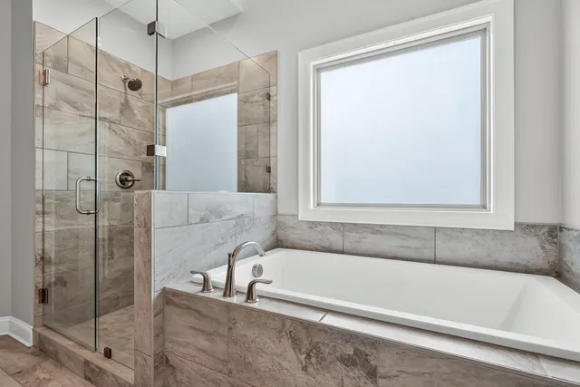 a bathroom with a bathtub and a shower