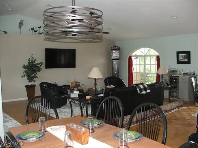 a view of a livingroom and dining room with furniture window and wooden floor