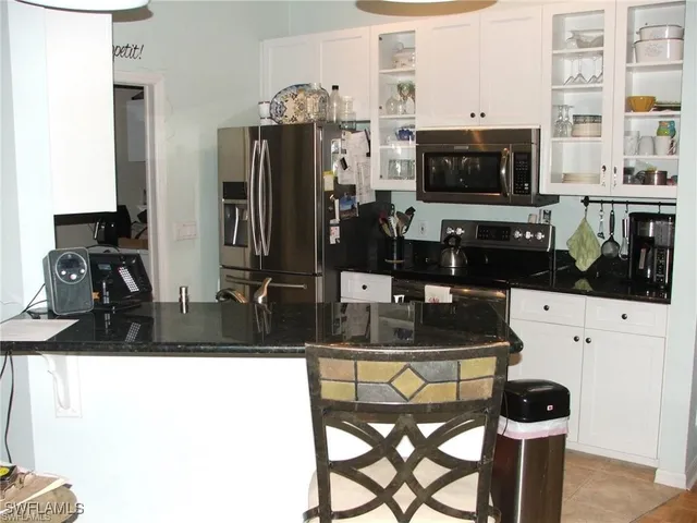 a kitchen with refrigerator and cabinets