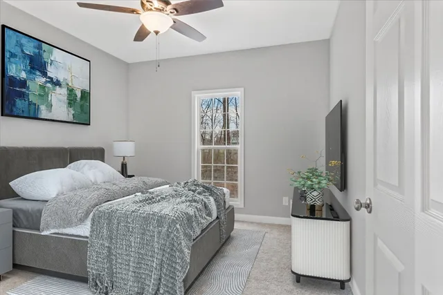 a bedroom with bed and ceiling fan