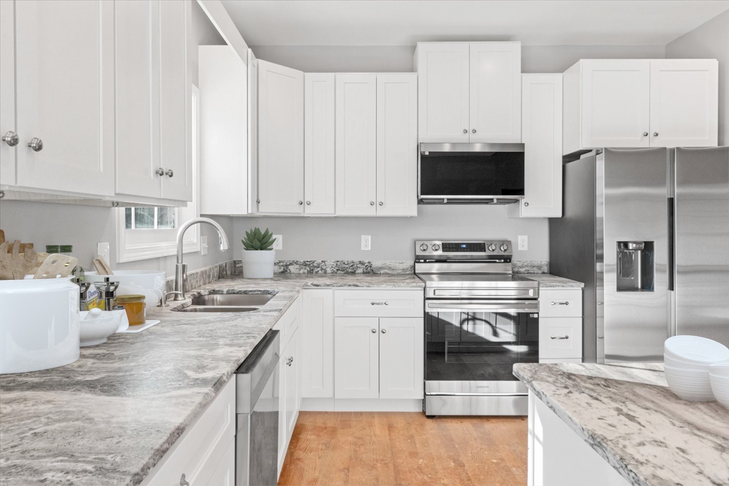 206 Daley Street Summertown, TN 38483 - Photo 8 of 16 a kitchen with granite countertop a sink stove and refrigerator