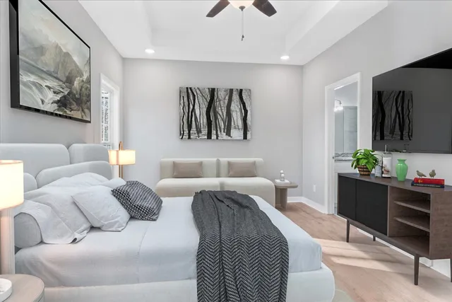 a living room with furniture and paintings on the wall