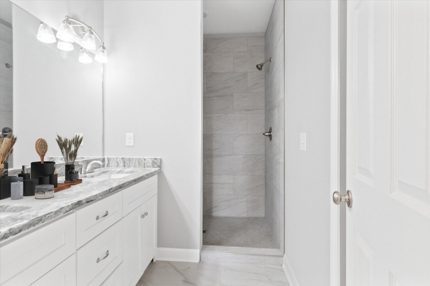 206 Daley Street Summertown, TN 38483 - Photo 10 of 16 a bathroom with a granite countertop sink a mirror and a shower