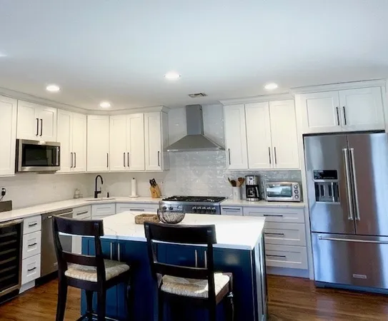 a kitchen with a dining table chairs refrigerator and cabinets
