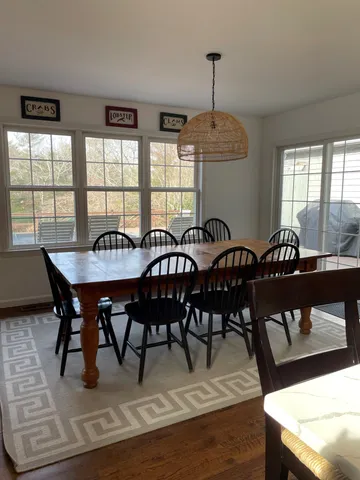 a view of a dining room with furniture window and outside view