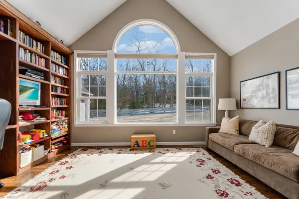a living room with furniture and a floor to ceiling window