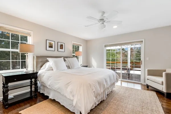a bedroom with a bed and a large window