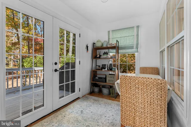 a living room with furniture a large window and walk in closet