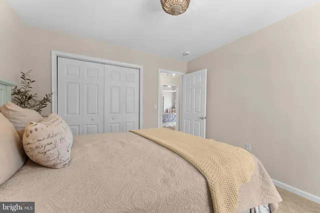 a spacious bedroom with a bed and a window