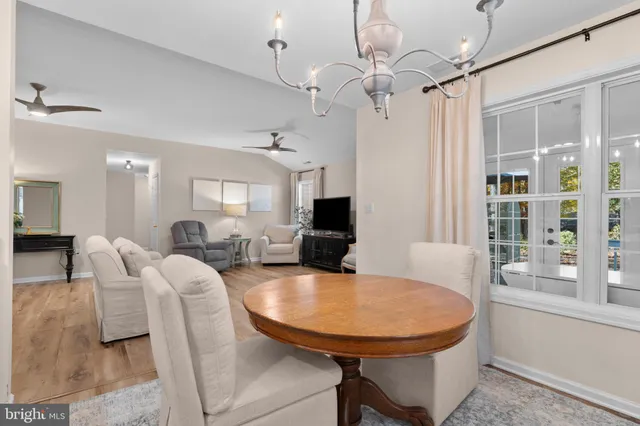 a living room with furniture a table and chairs