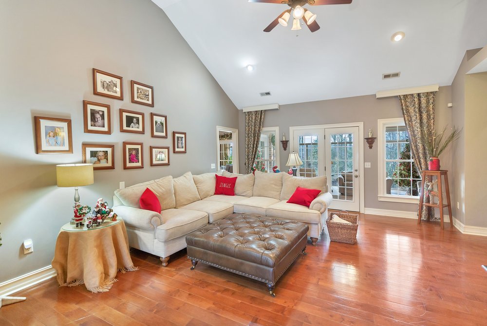 114 Augusta National Anderson, SC 29621 - Photo 3 of 47 Hardwood floors and soaring vaulted ceilings define this inviting living room, opening to the outdoor space.