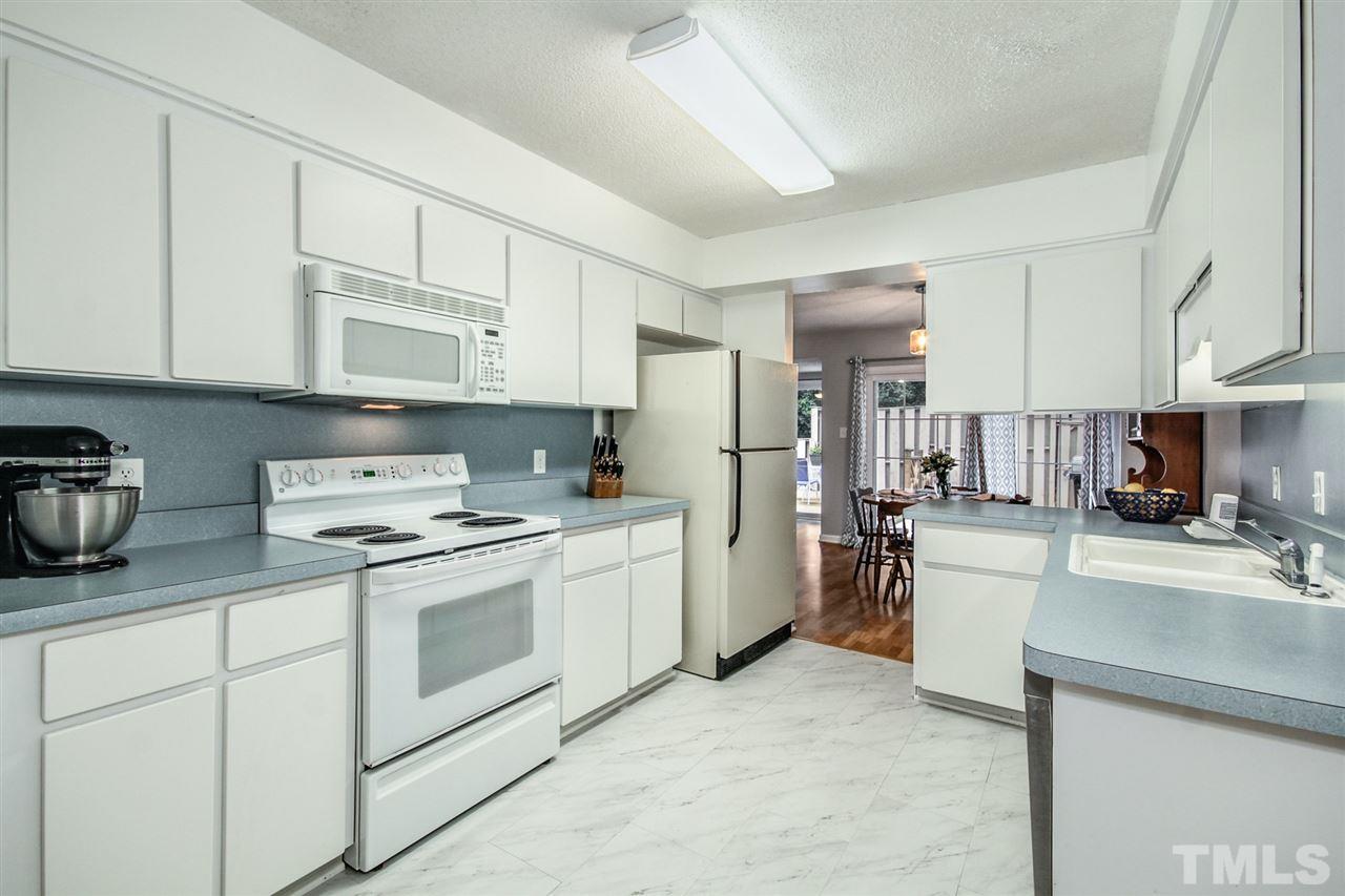 5863 Branchwood Road Raleigh, NC 27609 - Photo 12 of 30 a kitchen with cabinets and stainless steel appliances
