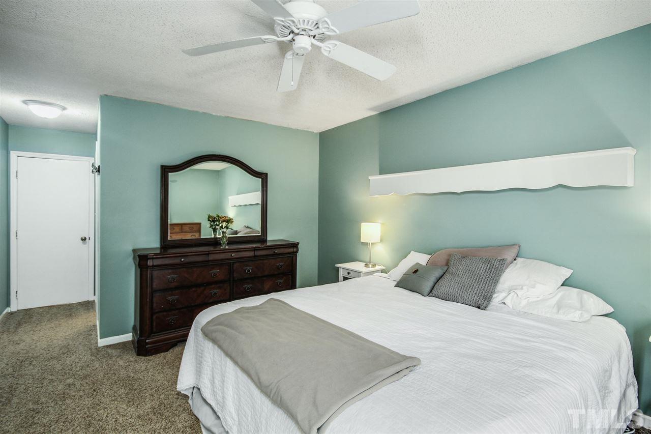 5863 Branchwood Road Raleigh, NC 27609 - Photo 16 of 30 a bedroom with a bed and a mirror on dresser