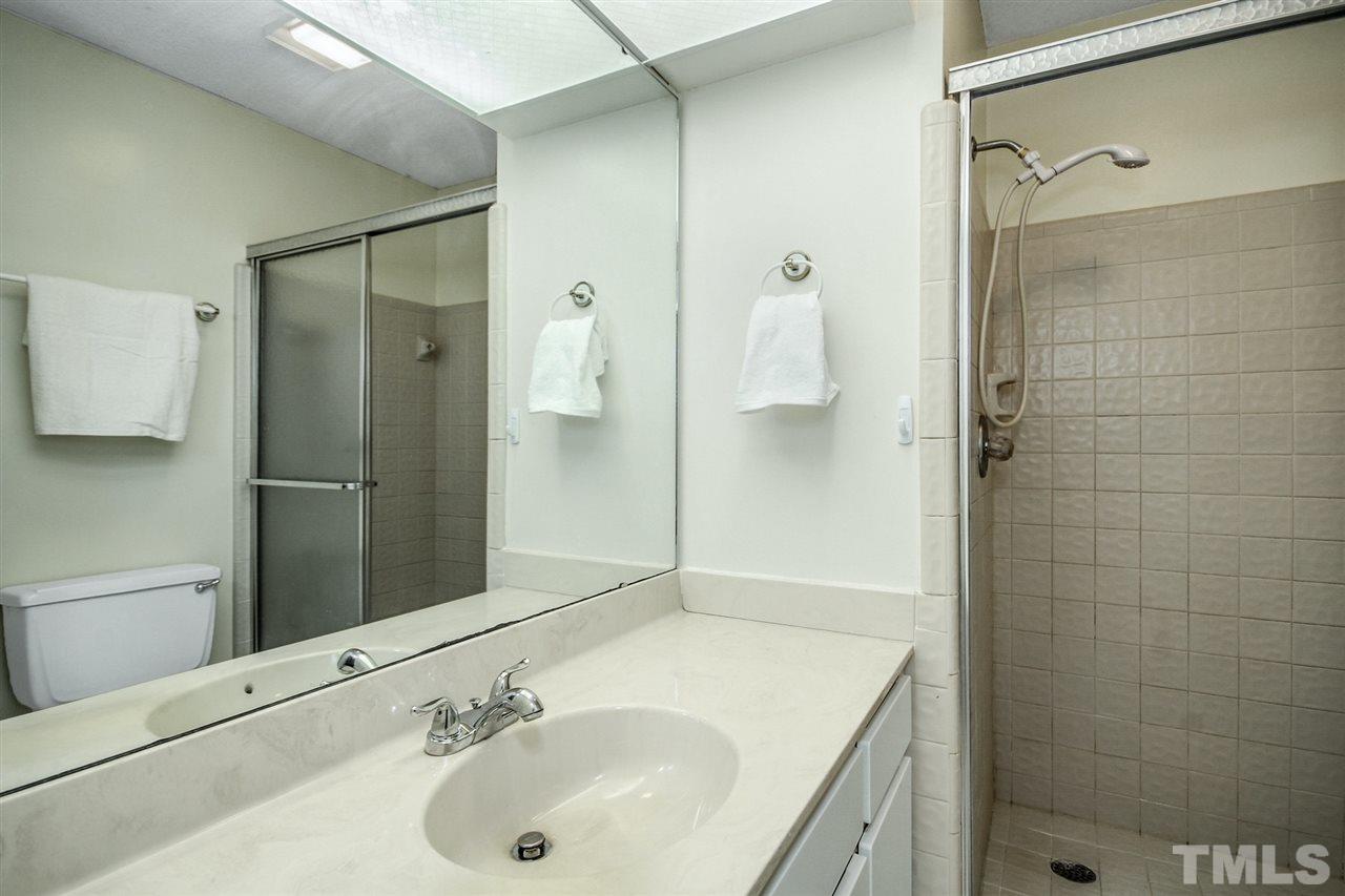 5863 Branchwood Road Raleigh, NC 27609 - Photo 18 of 30 a bathroom with a sink and a mirror