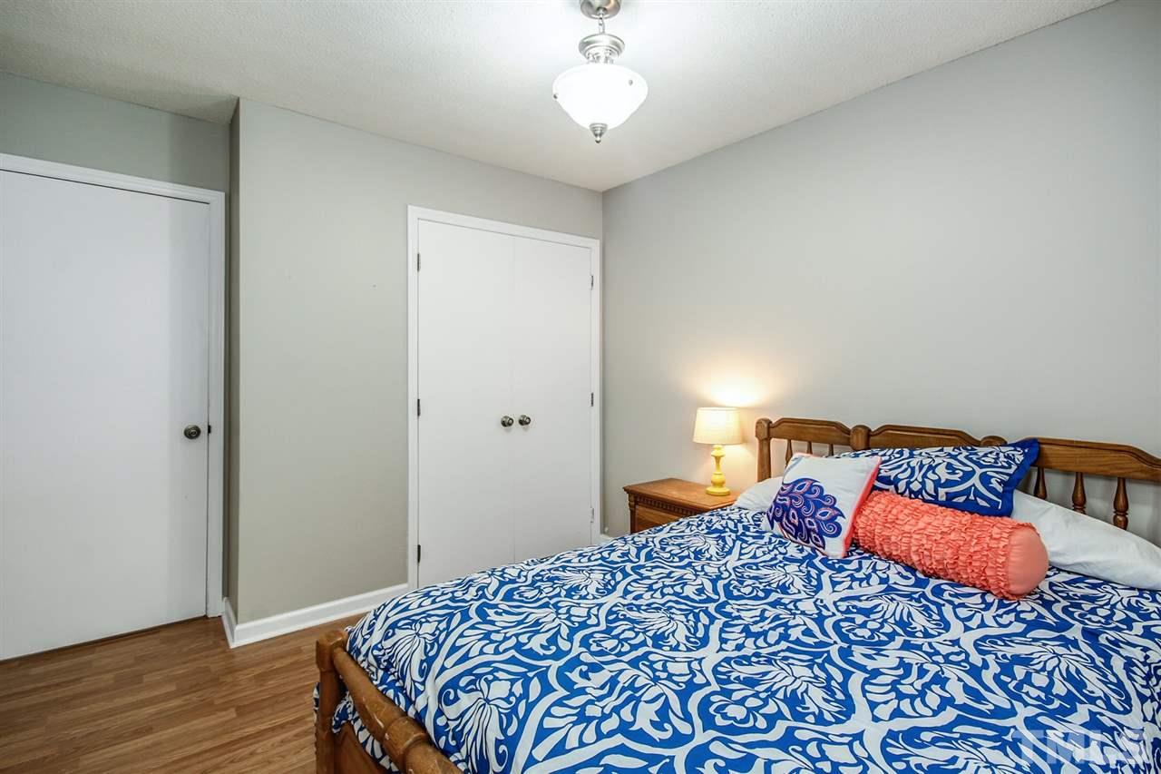 5863 Branchwood Road Raleigh, NC 27609 - Photo 20 of 30 a bedroom with a bed and wooden floor