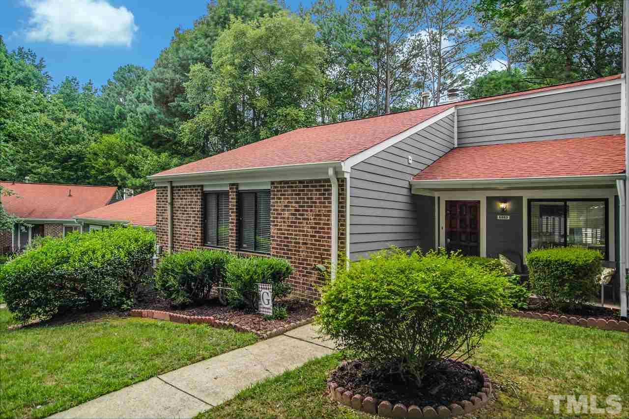 5863 Branchwood Road Raleigh, NC 27609 - Photo 3 of 30 a view of a house with a yard plants and large tree