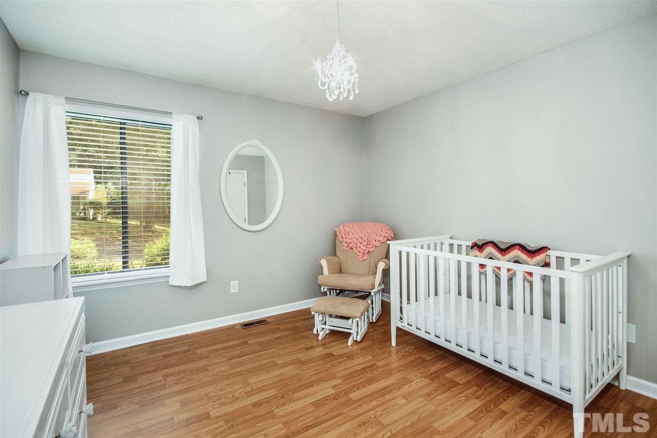 5863 Branchwood Road Raleigh, NC 27609 - Photo 21 of 30 a bedroom with a bed and a window