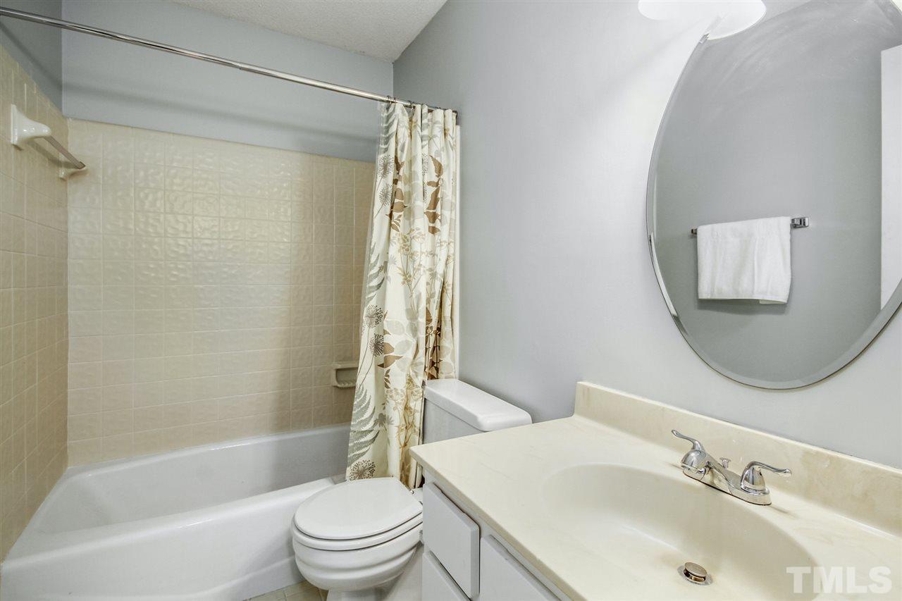 5863 Branchwood Road Raleigh, NC 27609 - Photo 23 of 30 a bathroom with a sink toilet and shower