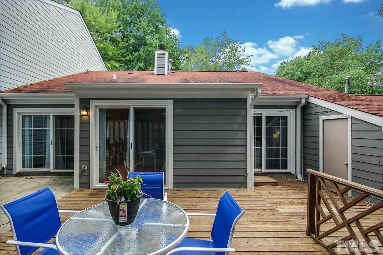 5863 Branchwood Road Raleigh, NC 27609 - Photo 24 of 30 a view of house with patio outdoor seating and green space