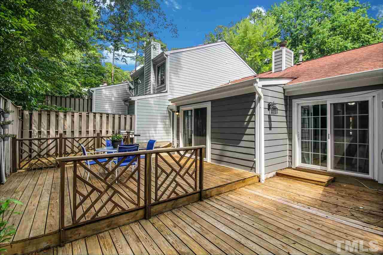 5863 Branchwood Road Raleigh, NC 27609 - Photo 25 of 30 a view of a deck with wooden floor and fence next to a yard