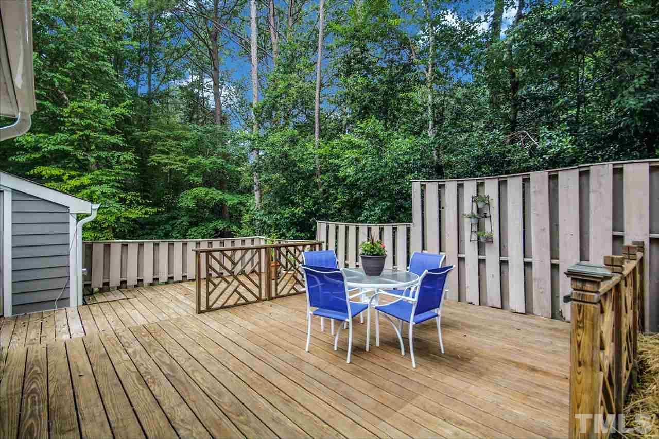 5863 Branchwood Road Raleigh, NC 27609 - Photo 26 of 30 a roof deck with table and chairs and wooden floor