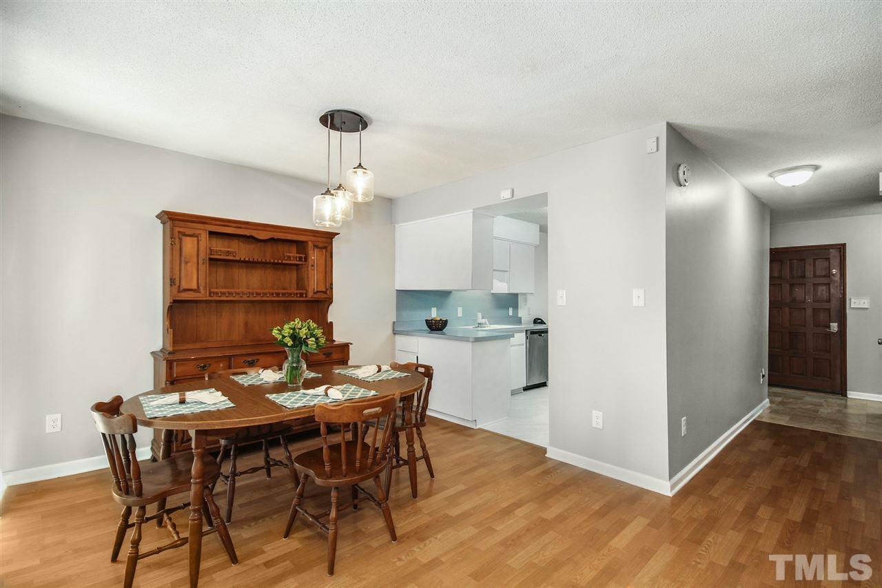 5863 Branchwood Road Raleigh, NC 27609 - Photo 10 of 30 a view of a dining room with furniture and wooden floor