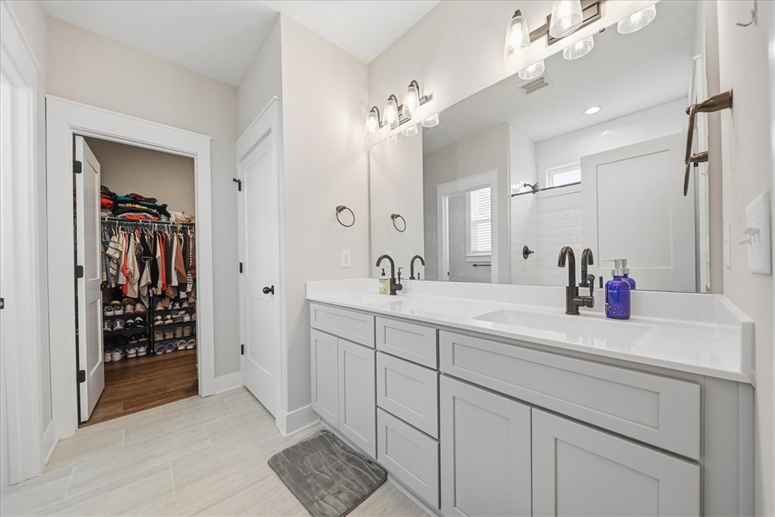 214 Timothy Court Anderson, SC 29621 - Photo 27 of 43 Dual vanities and a spacious walk-in closet highlight this elegantly designed primary bathroom.