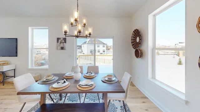 a view of a dining room with furniture and chandelier