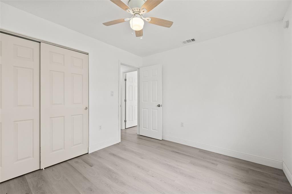 8046 Norwich Drive Port Richey, FL 34668 - Photo 15 of 31 wooden floor in an empty room