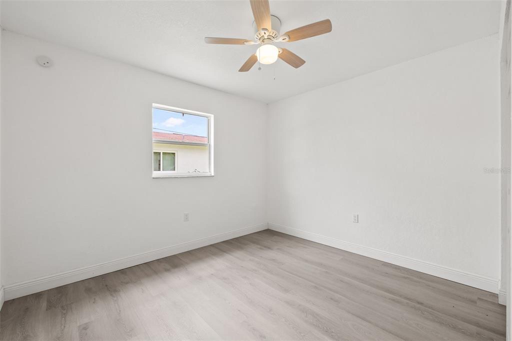 8046 Norwich Drive Port Richey, FL 34668 - Photo 17 of 31 an empty room with a window and a fan