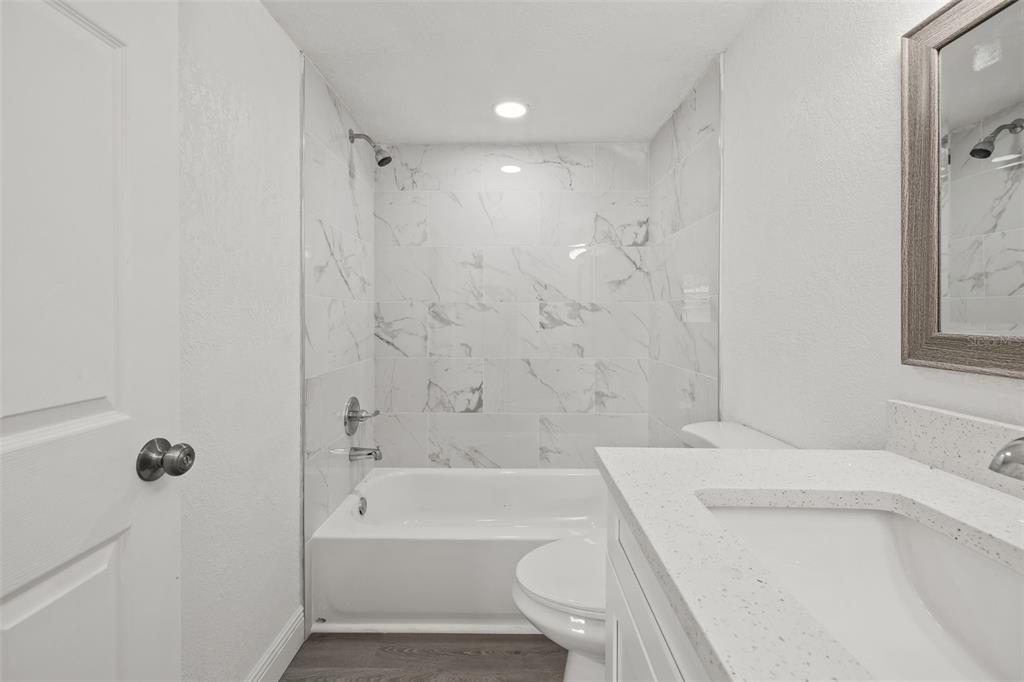 8046 Norwich Drive Port Richey, FL 34668 - Photo 18 of 31 a bathroom with a sink a toilet and a bathtub