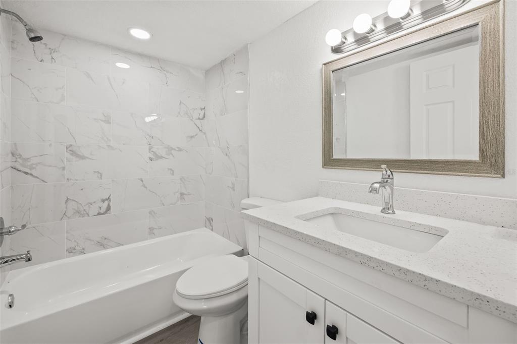 8046 Norwich Drive Port Richey, FL 34668 - Photo 19 of 31 a bathroom with a sink a toilet and a bathtub