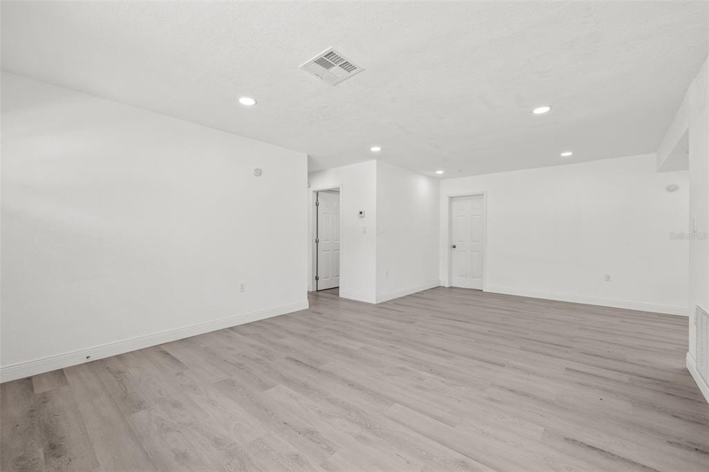 8046 Norwich Drive Port Richey, FL 34668 - Photo 22 of 31 a view of an empty room with wooden floor