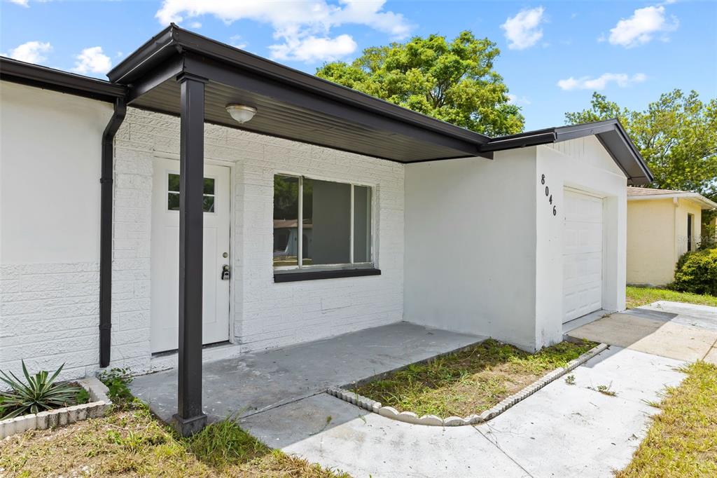 8046 Norwich Drive Port Richey, FL 34668 - Photo 7 of 31 a backyard of a house with potted plants
