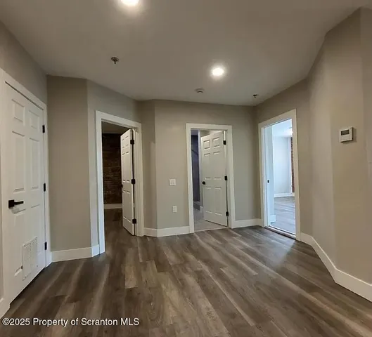 an empty room with closet and wooden floor