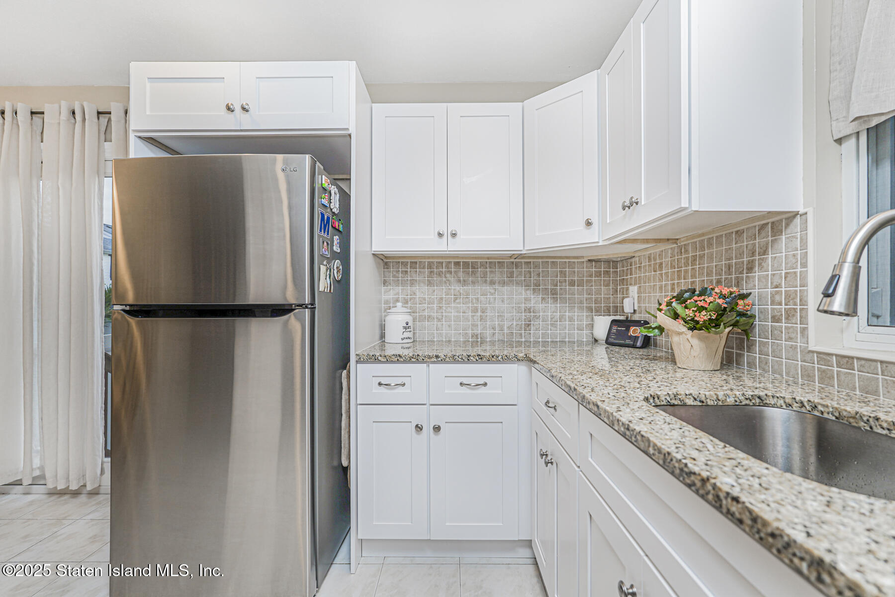 342 Chelsea Street Staten Island, NY 10307 - Photo 11 of 35 a kitchen with a refrigerator sink and cabinets