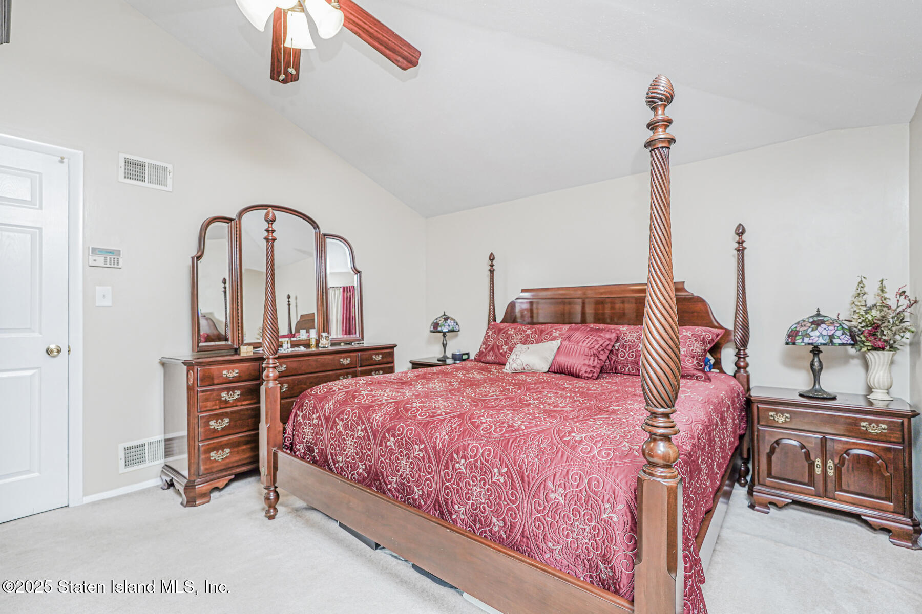 342 Chelsea Street Staten Island, NY 10307 - Photo 17 of 35 a bedroom with a bed and a chandelier