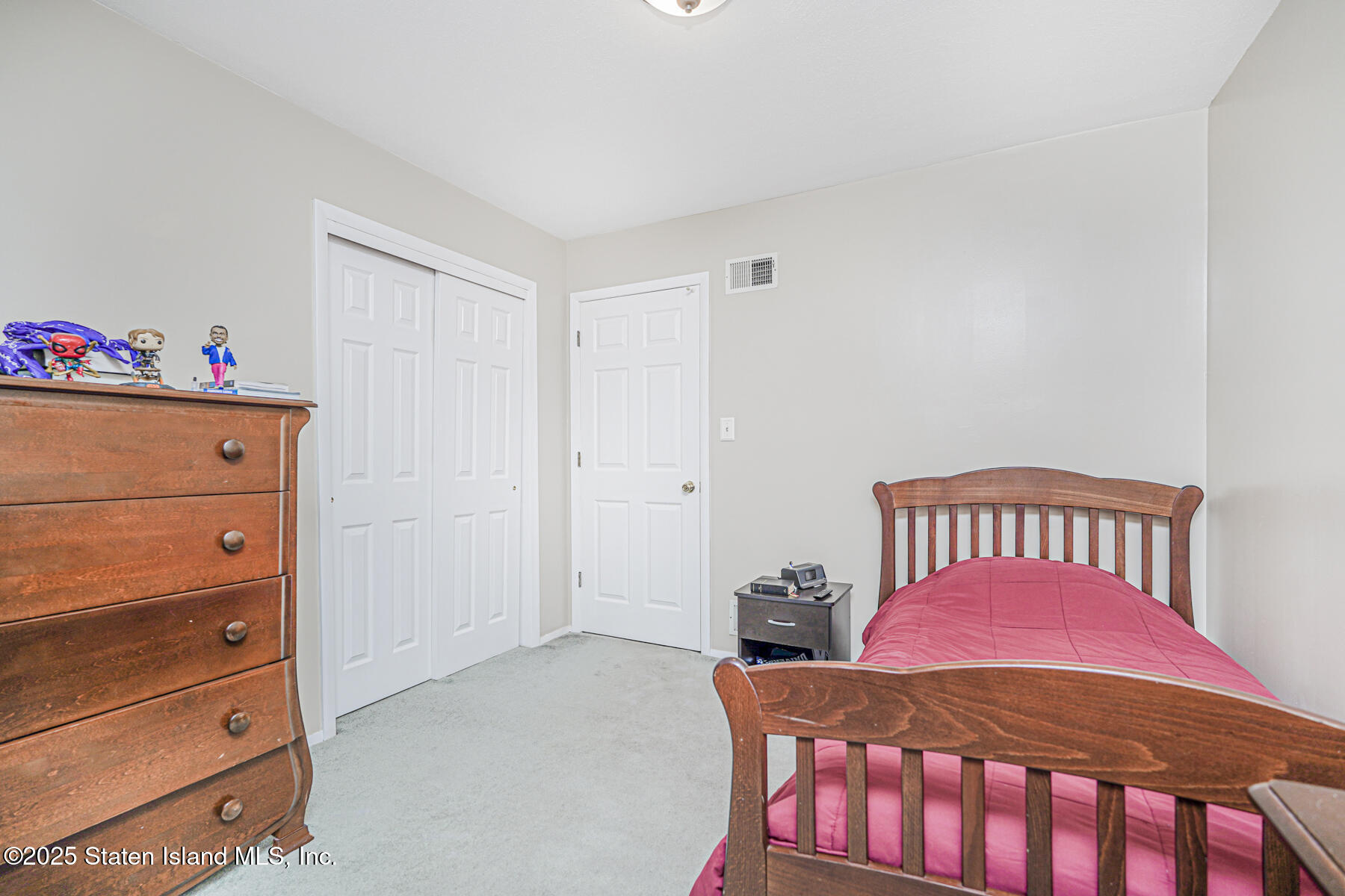 342 Chelsea Street Staten Island, NY 10307 - Photo 19 of 35 a bedroom with a bed and a dresser