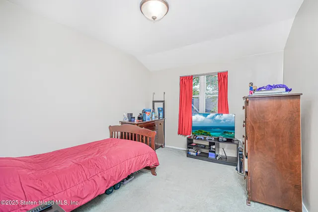 a bedroom with furniture and a flat screen tv