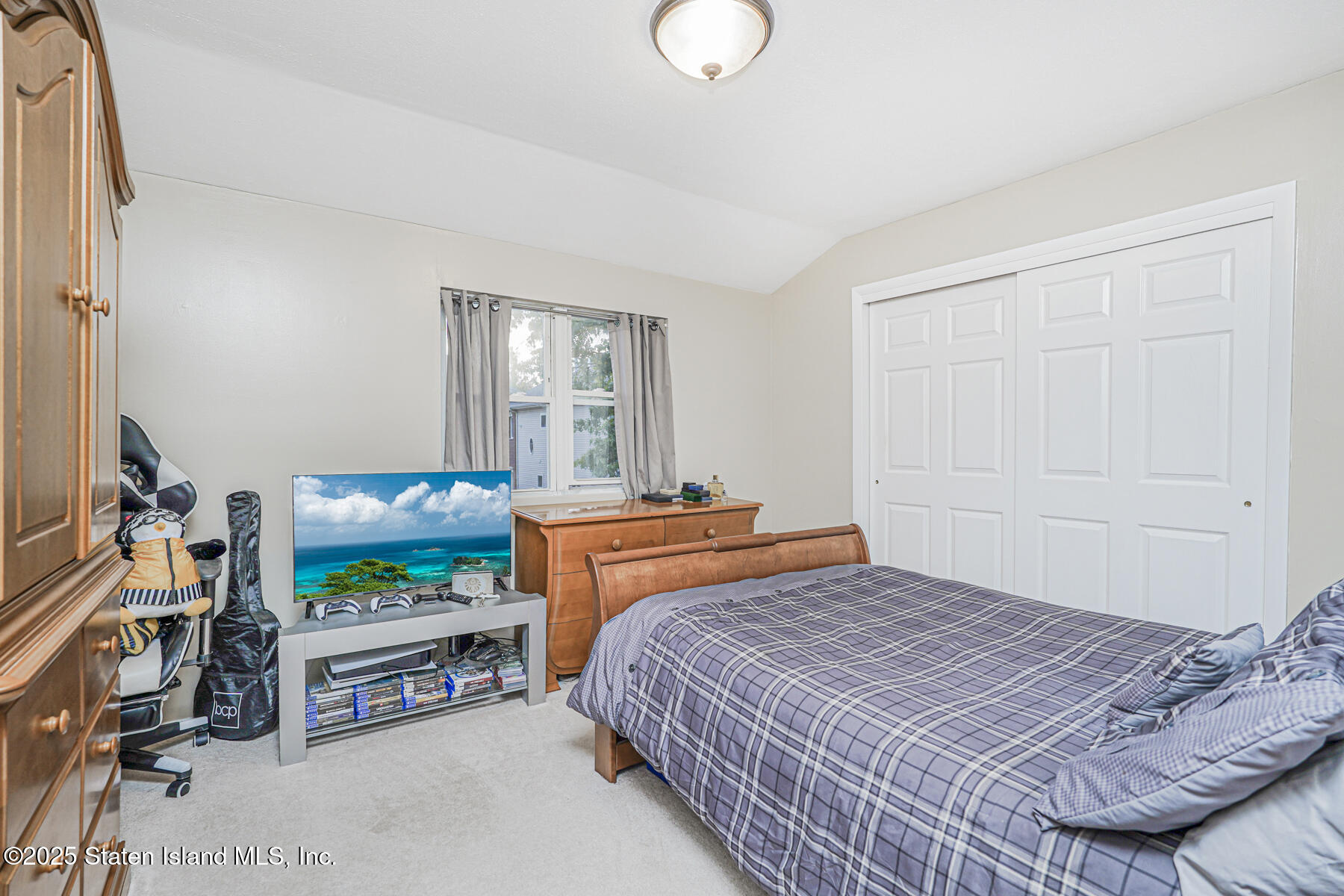 342 Chelsea Street Staten Island, NY 10307 - Photo 22 of 35 a bedroom with a bed and a flat screen tv